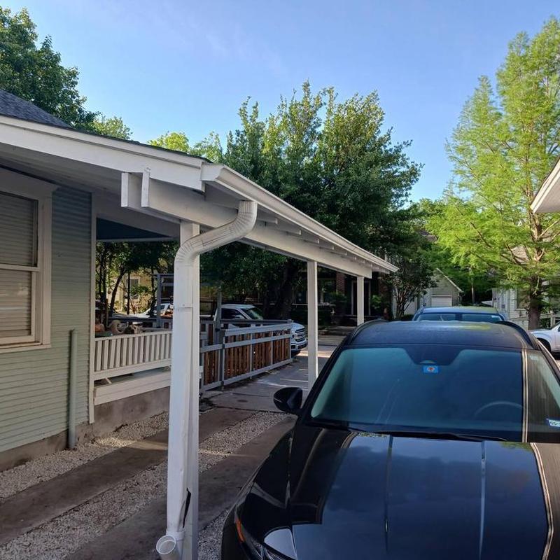 Gutter downspout extended and connected to French drain