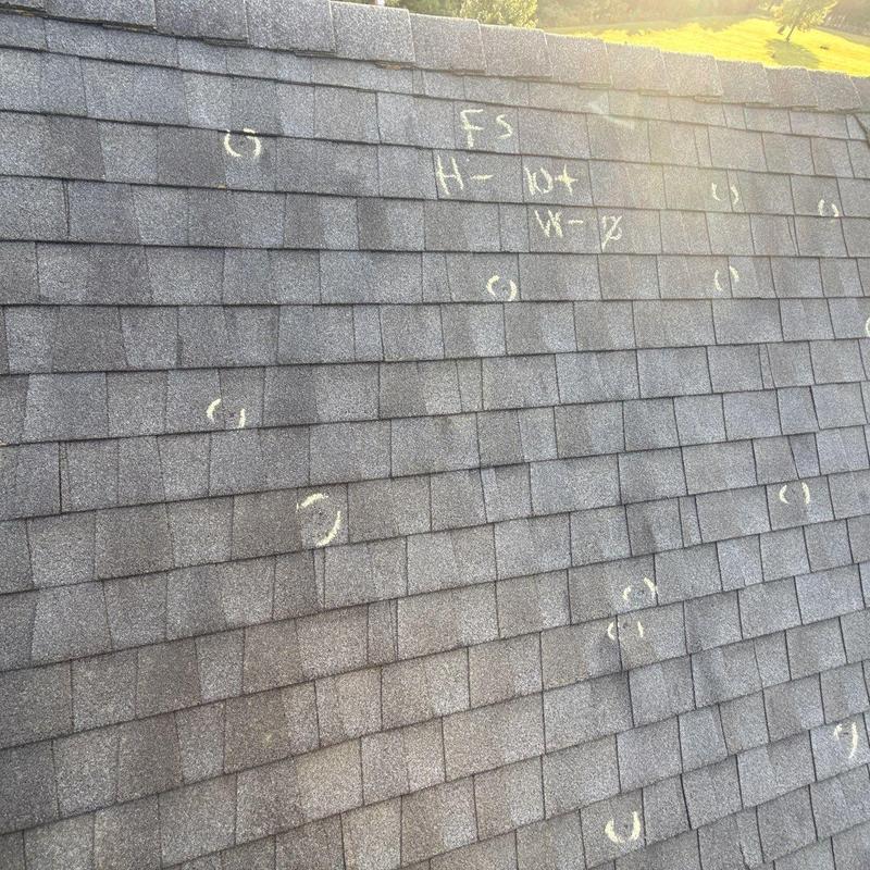 Asphalt shingle roof with hail damage markings