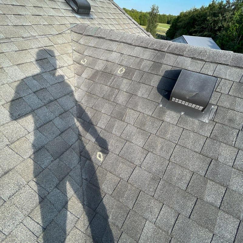 Asphalt shingles with hail damage marks on roof