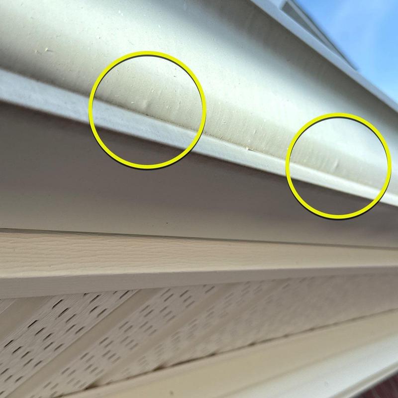 Metal gutter dent damage with circled impact areas