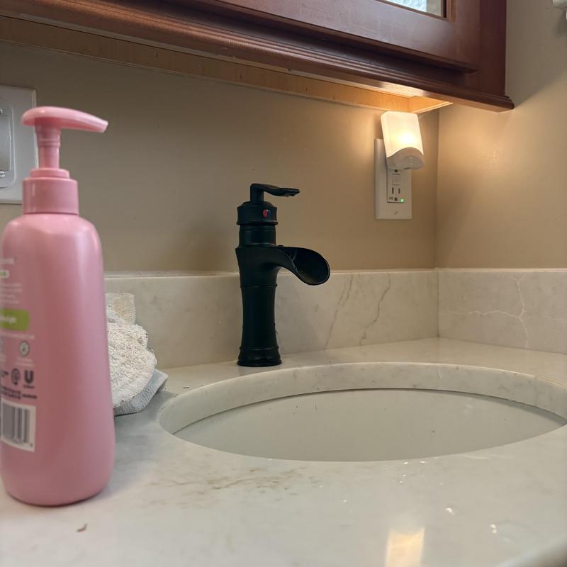 Bathroom sink faucet installation with new black faucet