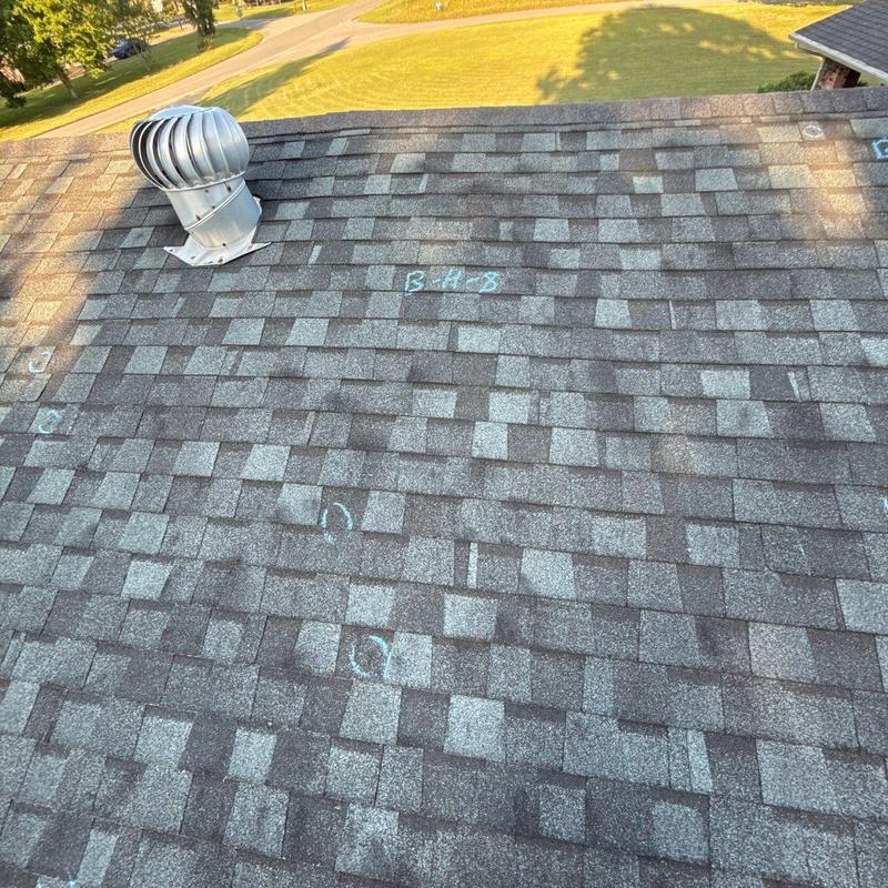 Asphalt shingle roof with hail damage markings