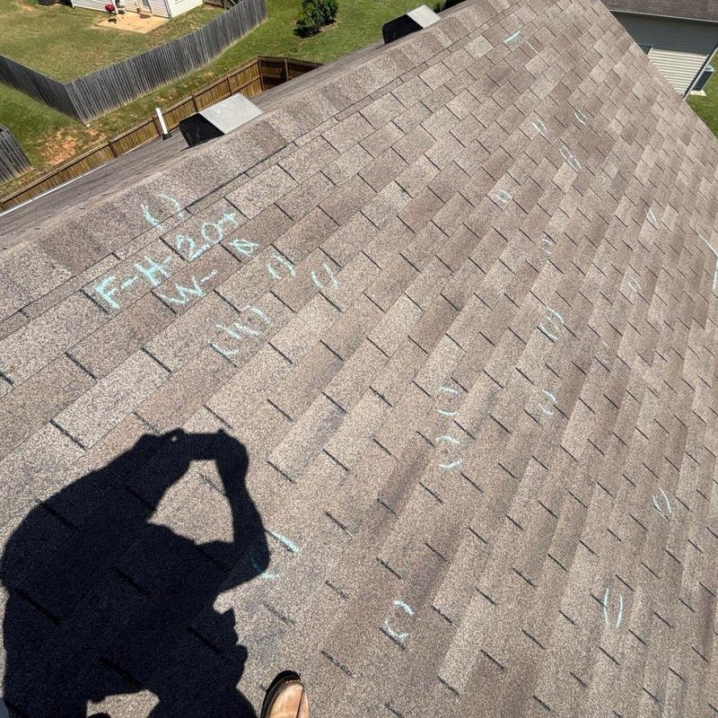 Asphalt shingle roof with chalk markings for hail damage
