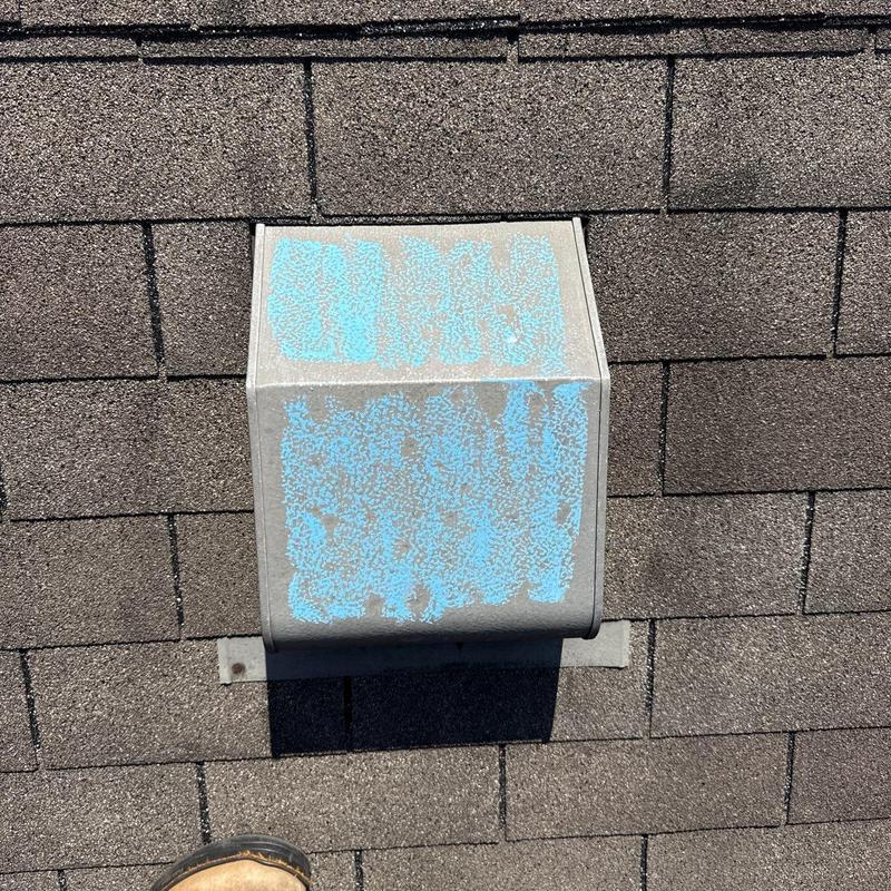 Roof vent with hail damage on asphalt shingles