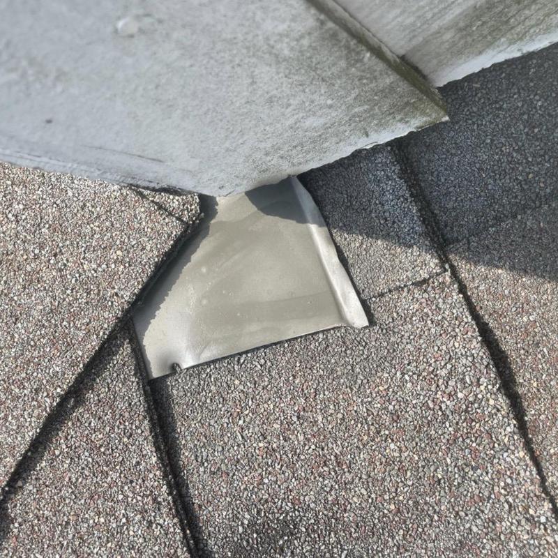 Roof-to-wall flashing with new step flashing installation