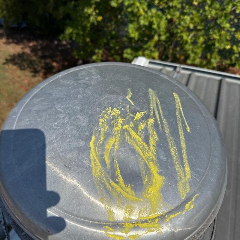 Metal roof vent cap with hail damage markings