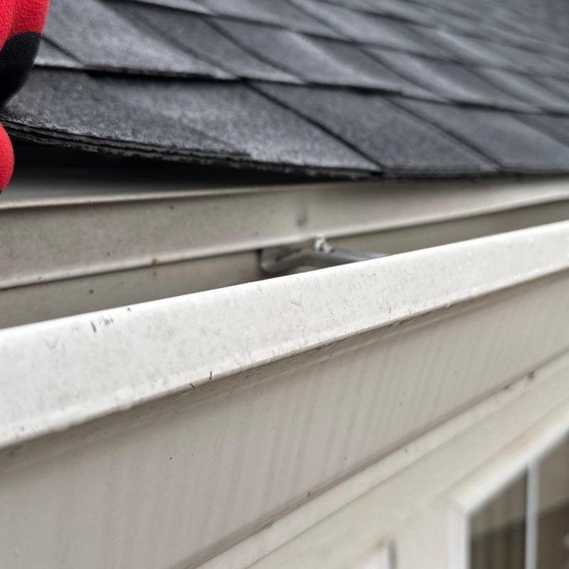 Roof shingles and gutter edge close-up inspection