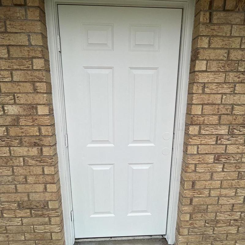 Exterior door trim with fresh paint and caulk