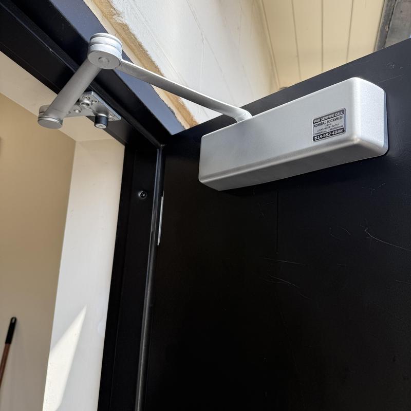 Door closer installation on service door at rental facility
