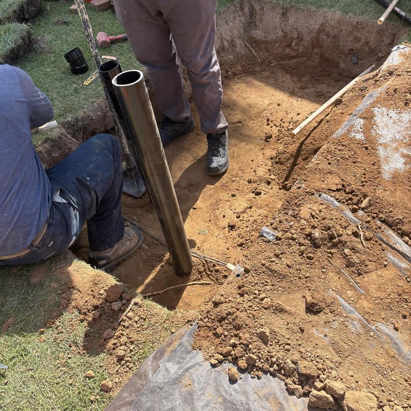 Drain pipe installation in excavation site Drain pipe installation in excavation site