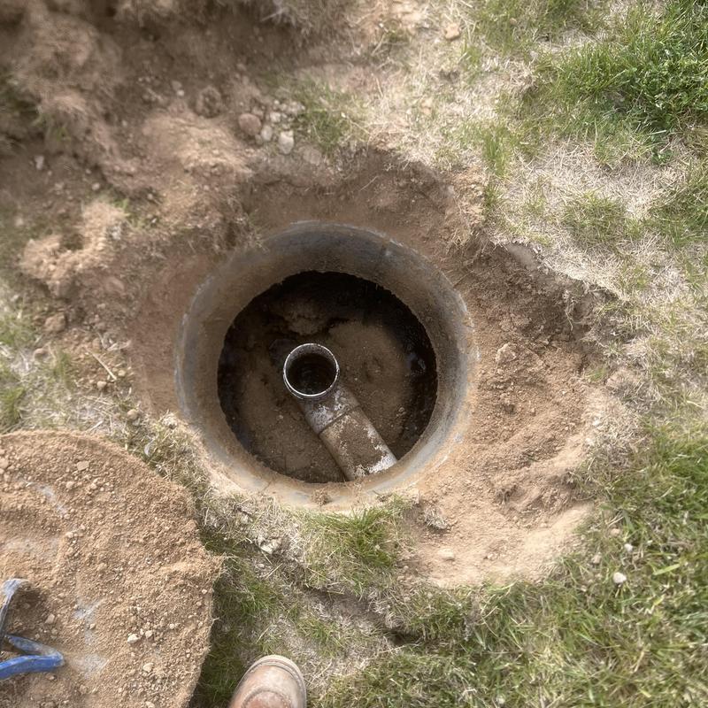 Septic tank inlet pipe with surrounding soil excavation