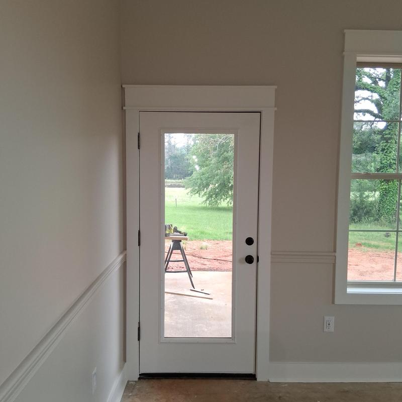 Glass door with white frame and black hardware