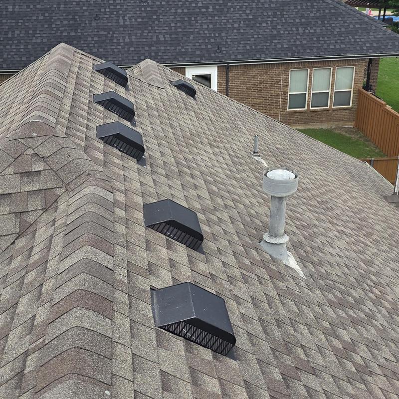 Asphalt shingle roof with vent covers and pipe flashing
