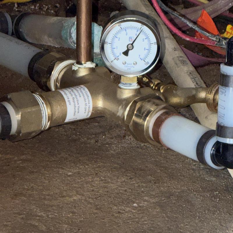 Water well pressure tank with pressure gauge and pipes