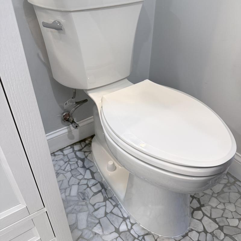 Toilet installation with new shutoff valve in bathroom