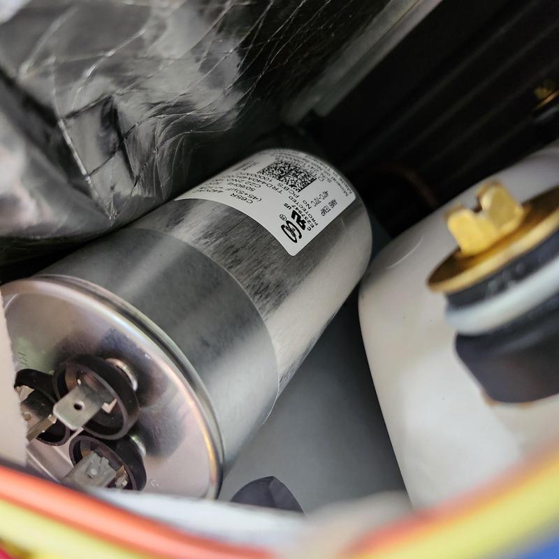 AC capacitor close-up inside unit compartment AC capacitor close-up inside unit compartment