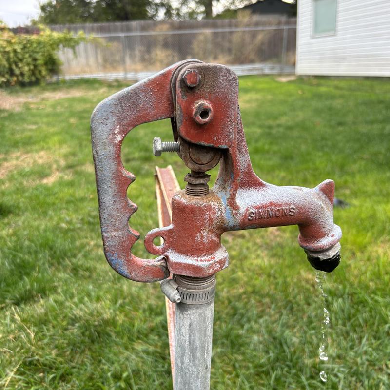 Old bury hydrant leaking water from spout outdoors