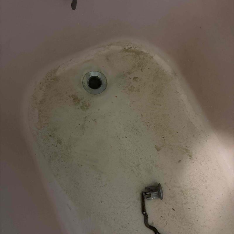 Bathtub drain with dirt and debris buildup