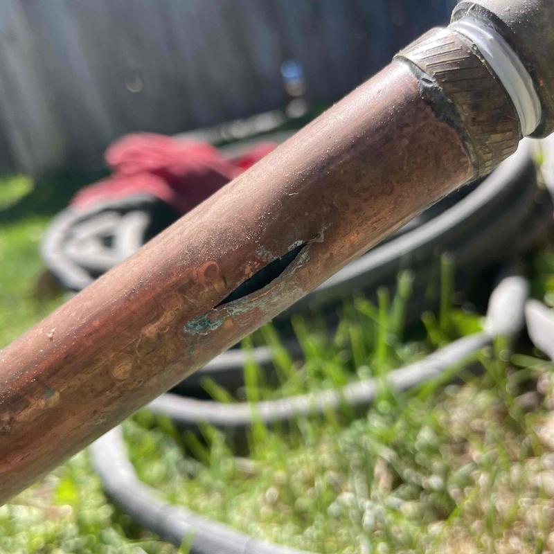 Copper pipe with split crack and corrosion damage
