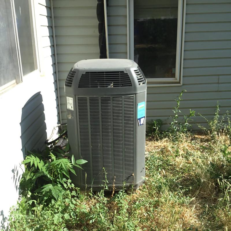 Outdoor air conditioner unit with dirty surrounding plants