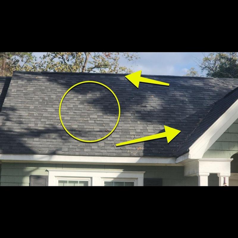 Asphalt roof shingles with damage marks and debris Asphalt roof shingles with damage marks and debris