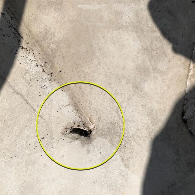 TPO roofing membrane puncture with surrounding dirt TPO roofing membrane puncture with surrounding dirt