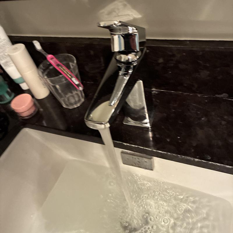 Bathroom faucet with running water in sink installation