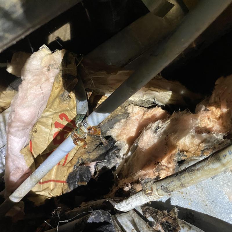 Polybutylene water pipe split leak under house with clamps