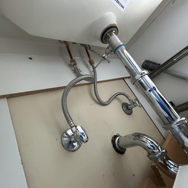 P-trap and quarter-turn angle stops under sink plumbing