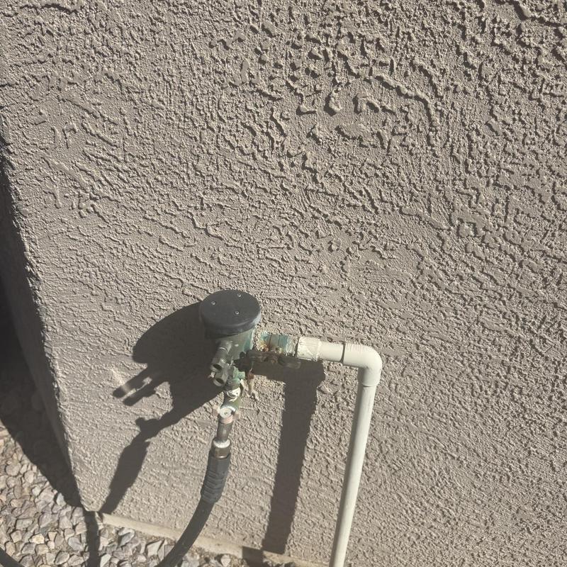 Pressure vacuum breaker with sink water line on stucco wall Pressure vacuum breaker with sink water line on stucco wall