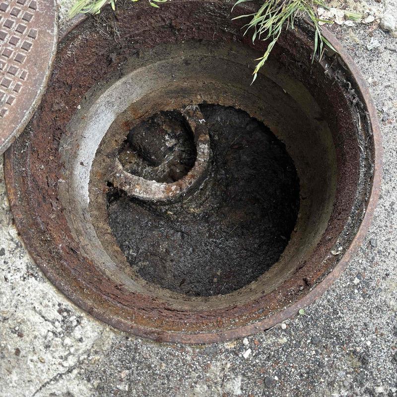 Full septic tank inside manhole view causing backup