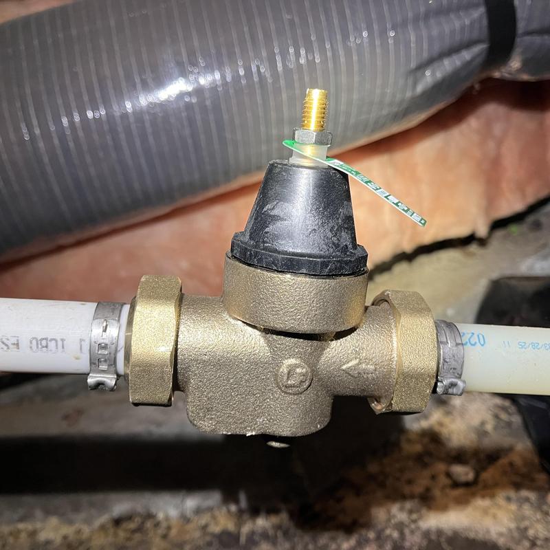 Pressure reducing valve (PRV) in crawlspace plumbing system