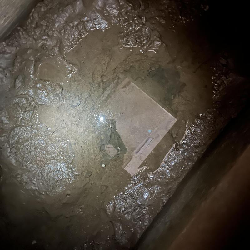 Water-filled meter pit with standing water inside