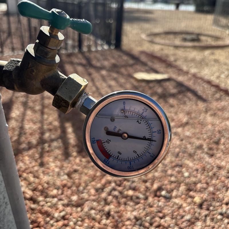 Hose bib water pressure gauge installed outdoors Hose bib water pressure gauge installed outdoors