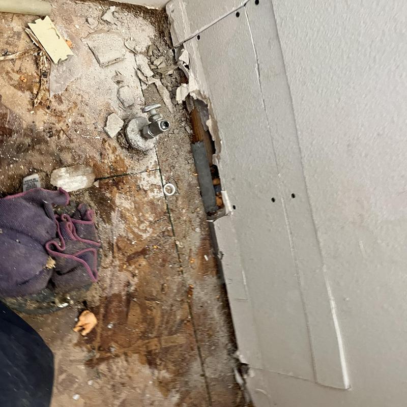 PEX waterlines behind drywall with cutout wall damage