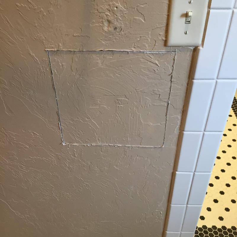 Bathroom wall access panel cut for shower valve installation