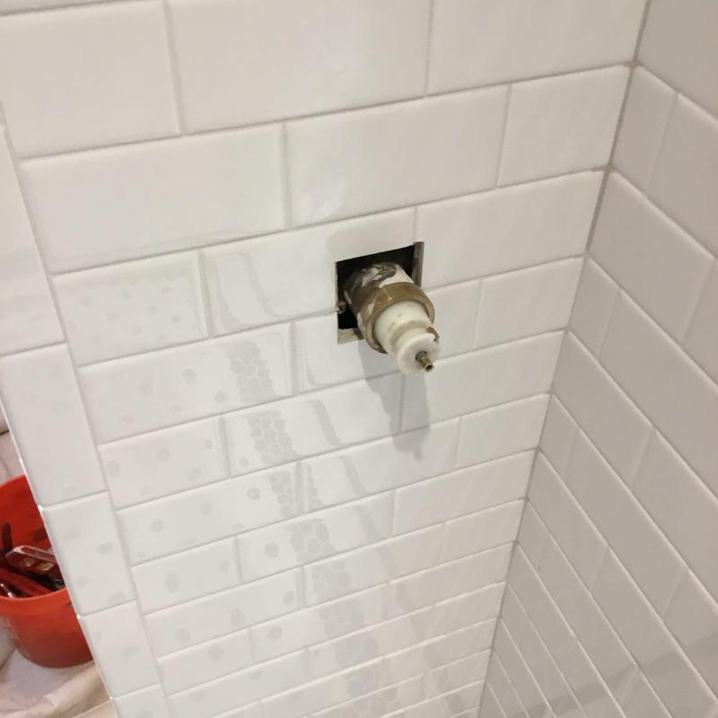 Moen shower valve protruding from tiled wall cavity