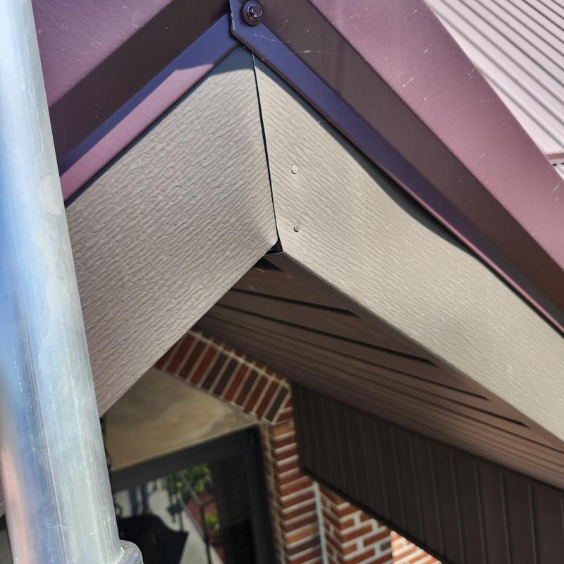 Metal roof ridge cap on high-pitched church roof