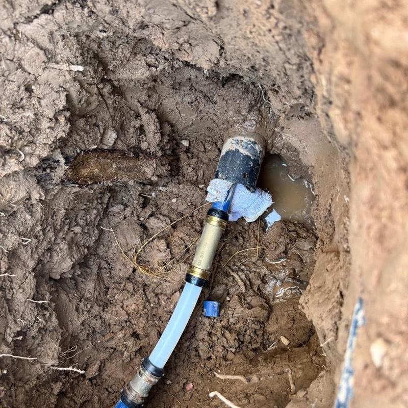 1 1/4 inch PEX water main repair with fittings in dirt