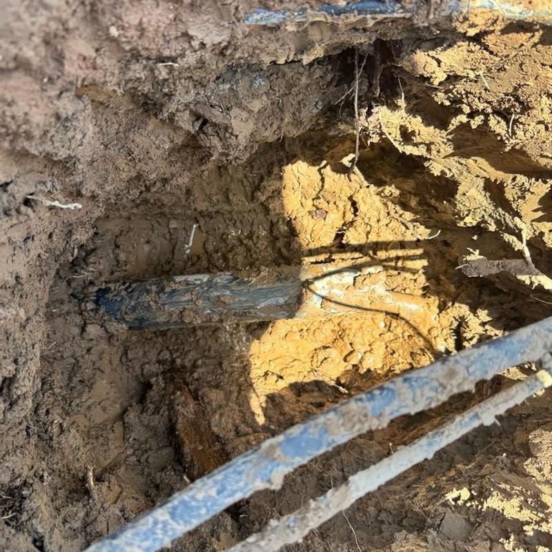 1 1/4 inch PEX water main exposed in dirt hole