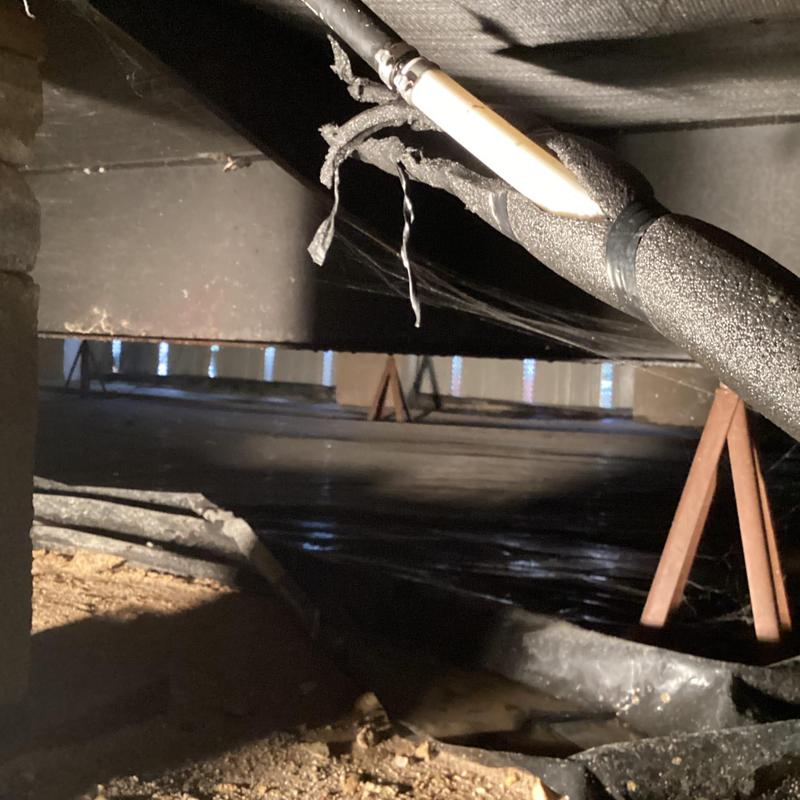 Plastic water line under home with leak and insulation