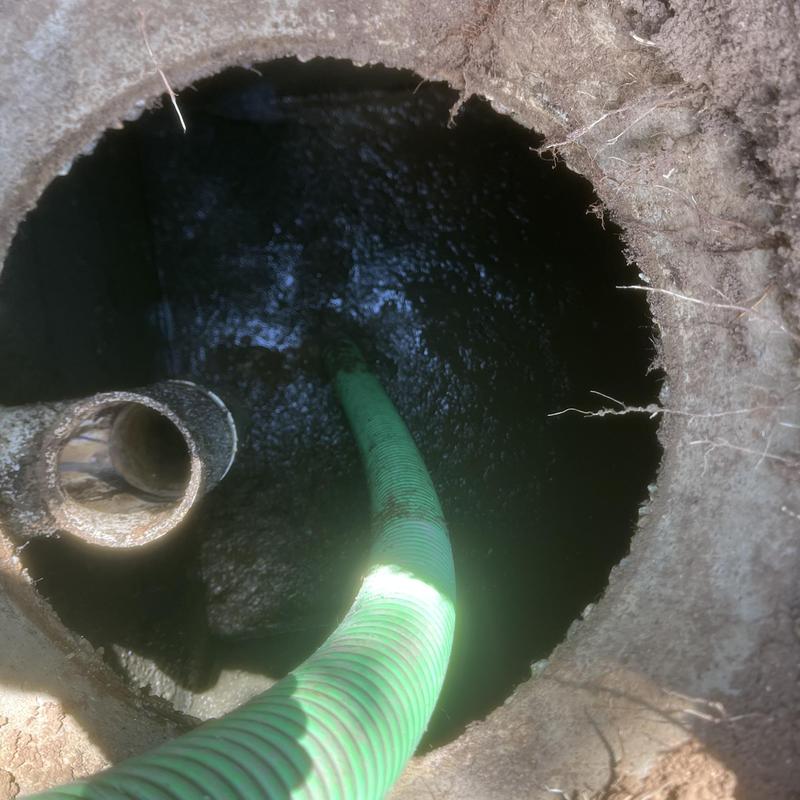 Septic tank interior with green pump-out hose