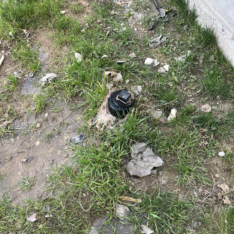 Sewer cleanout in muddy backyard near foundation wall