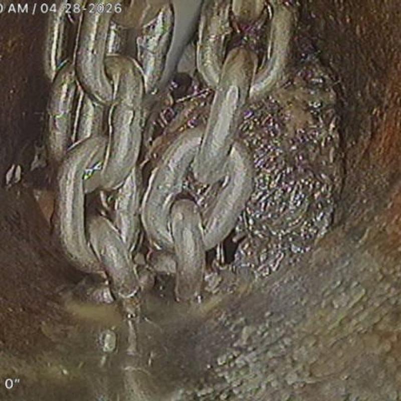 Sewer drain with chain snake cutting tree roots blockage