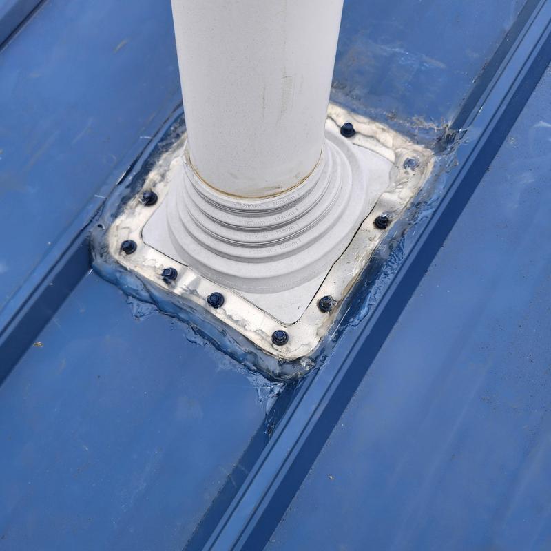 Vent pipe boot on metal roof with sealant and screws Vent pipe boot on metal roof with sealant and screws