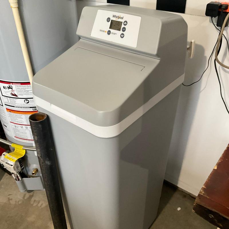 Water softener unit installation in residential basement
