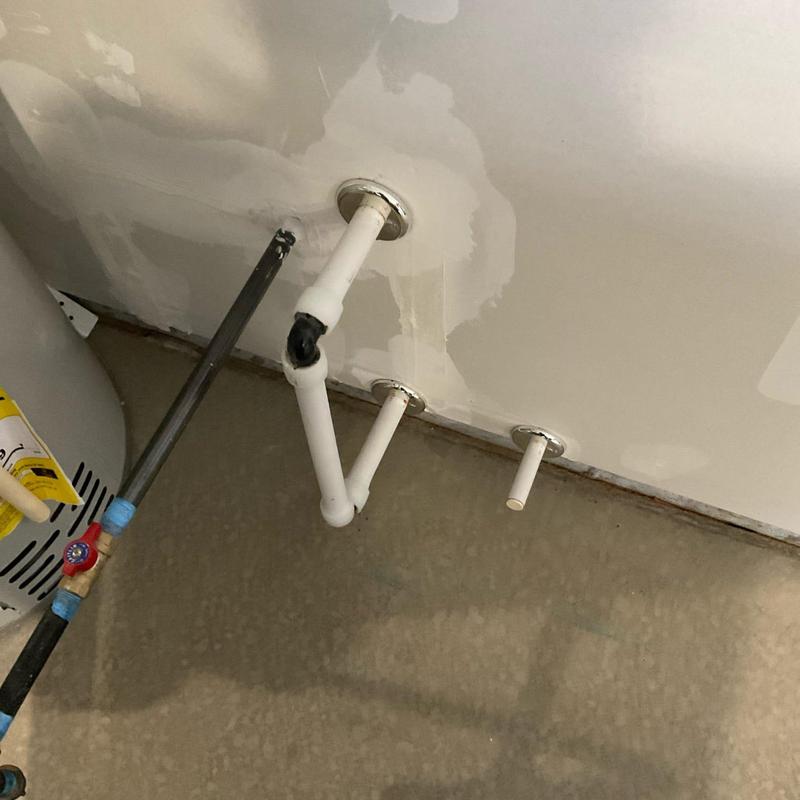 Softener plumbing connections in basement wall installation site