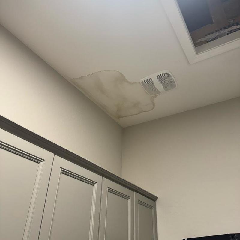 Laundry room ceiling water damage near vent fan