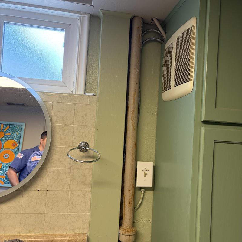 Basement bathroom drain pipe near vanity and vent