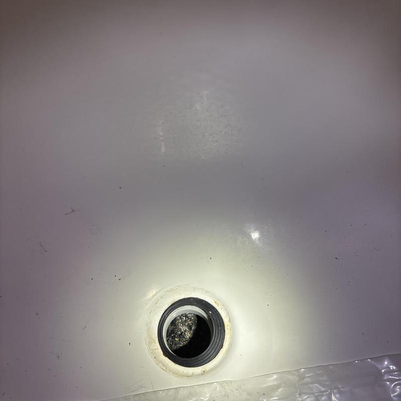 Tub drain opening in bathtub with removed stopper Tub drain opening in bathtub with removed stopper